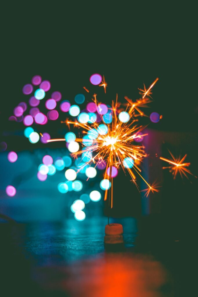 A dynamic sparkler igniting against a colorful bokeh background, perfect for celebrations.